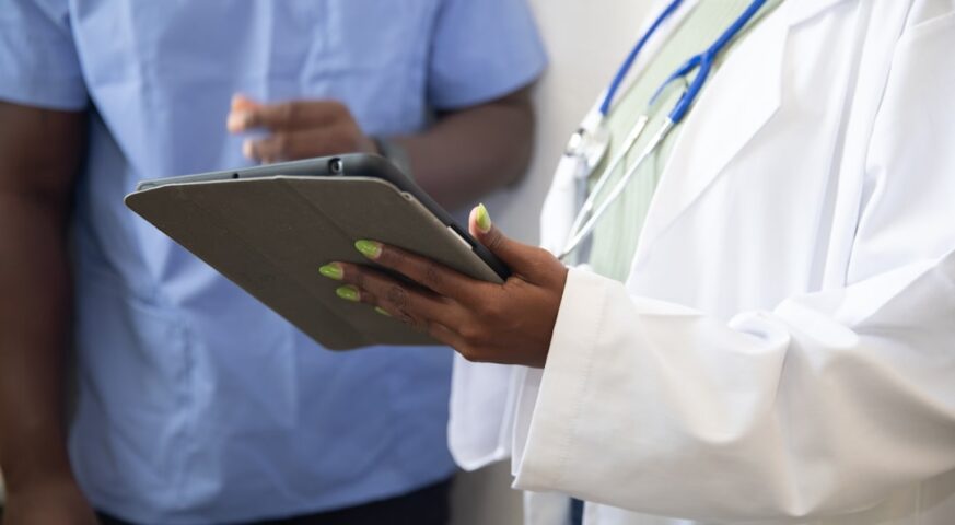 Black doctor consulting with a patient in a hospital