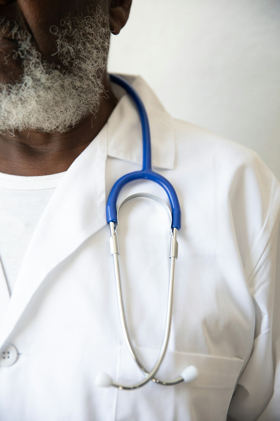 Black male doctor with a stethoscope in a clinical setting